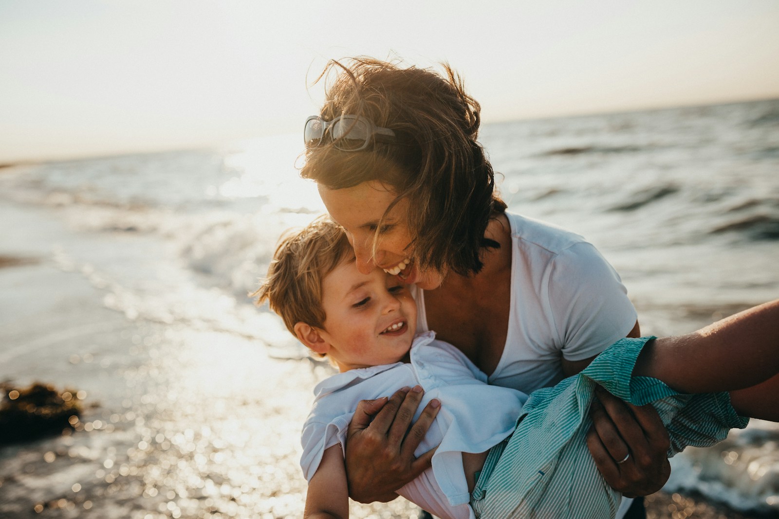 photo of mother and child beside body of water, life